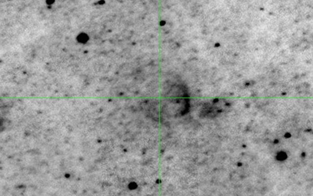 Green crosshairs on greyscale image of remnant of exploding star